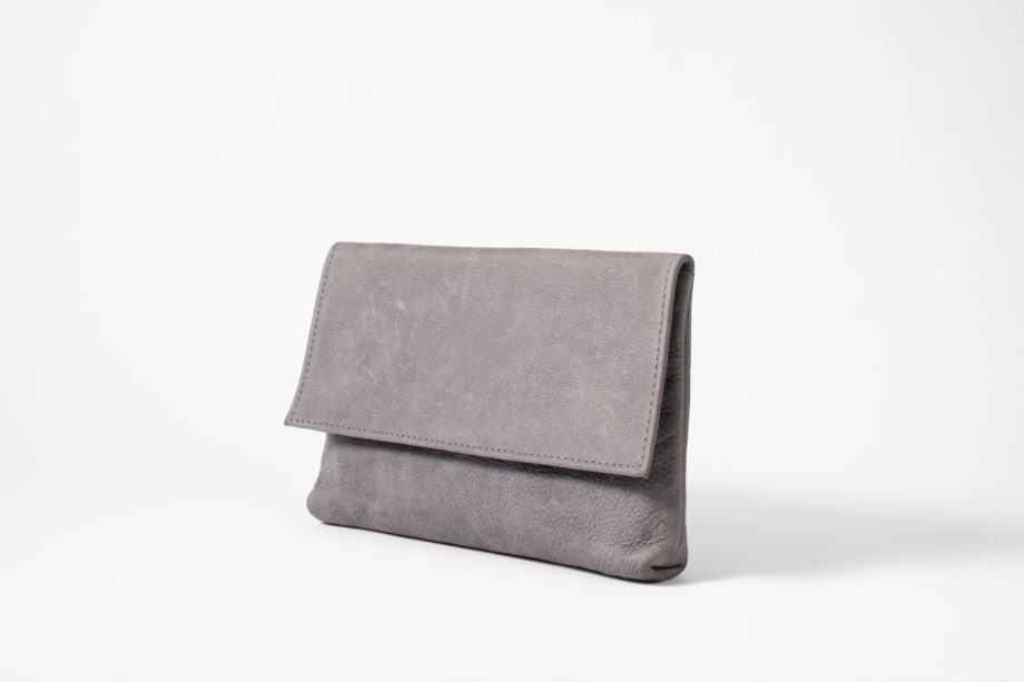 Front side view on an upstanding blue-greyish vegetable tanned Leather Clutch with invisible magnet opening