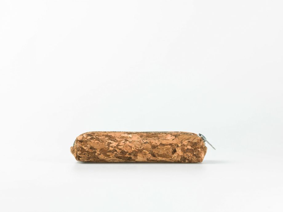 Lateral view on a dark patched patterned cork pencilcase with a silver zip opening